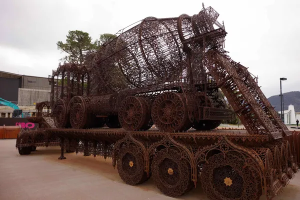 Cement truck on top of flatbed truck (Wim Delvoye)